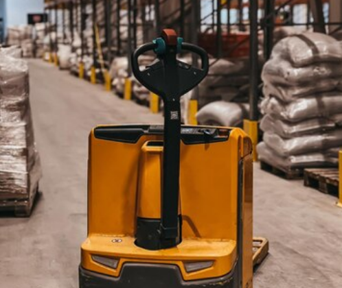 Battery Operated Pallet Truck used by worker in warehouse